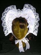 Unique bonnet has heart-shape above the head.