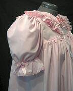 Side view shows puffy sleeve with bow embellishment.