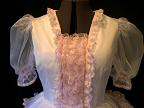 Bodice is split, and decorated with rows and rows of gathered pink lace.